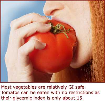 Tomatoes are a safe glycemic option. Girl taking a bite of a tomato.